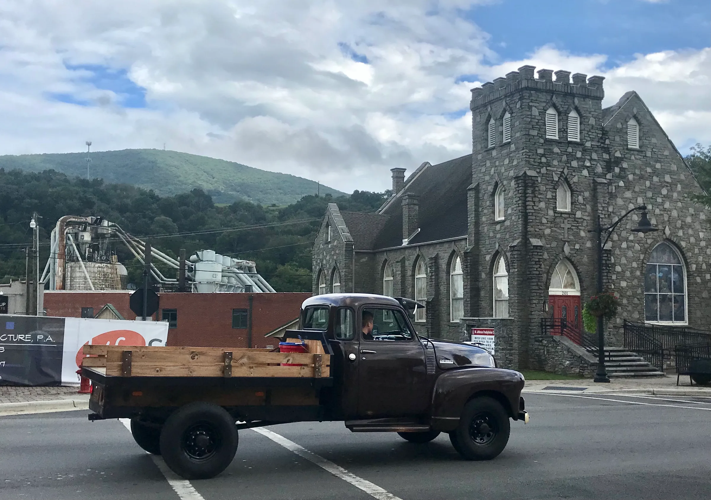 Vintage truck passing Mt Jefferson Presbyterian Church at East Ashe Avenue in West Jefferson, NC.