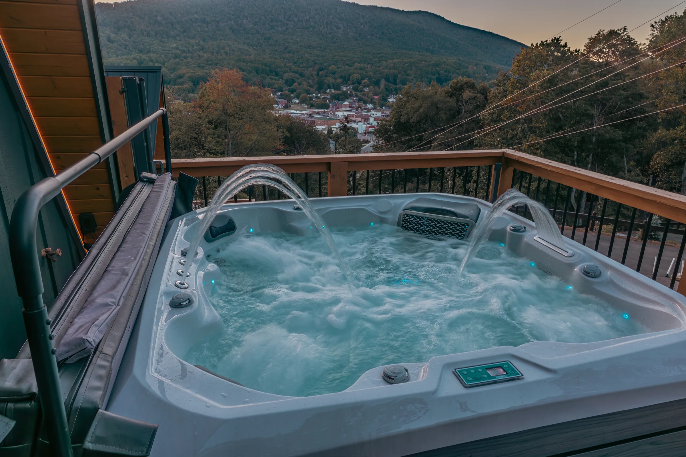 A High Peak hot tub on a deck above turning ridge trees in West Jefferson, NC.
