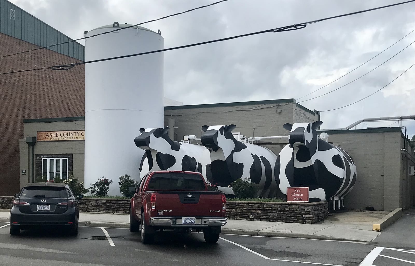 The Ashe County Cheese plant on East Main Street in West Jefferson, a low building with a green roof and a cupola
