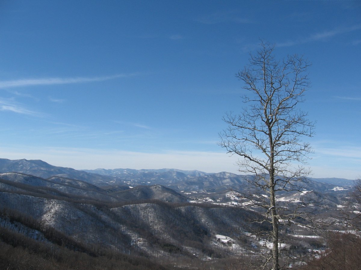 Snow-dusted ridgelines stretching west under a clear winter sky.