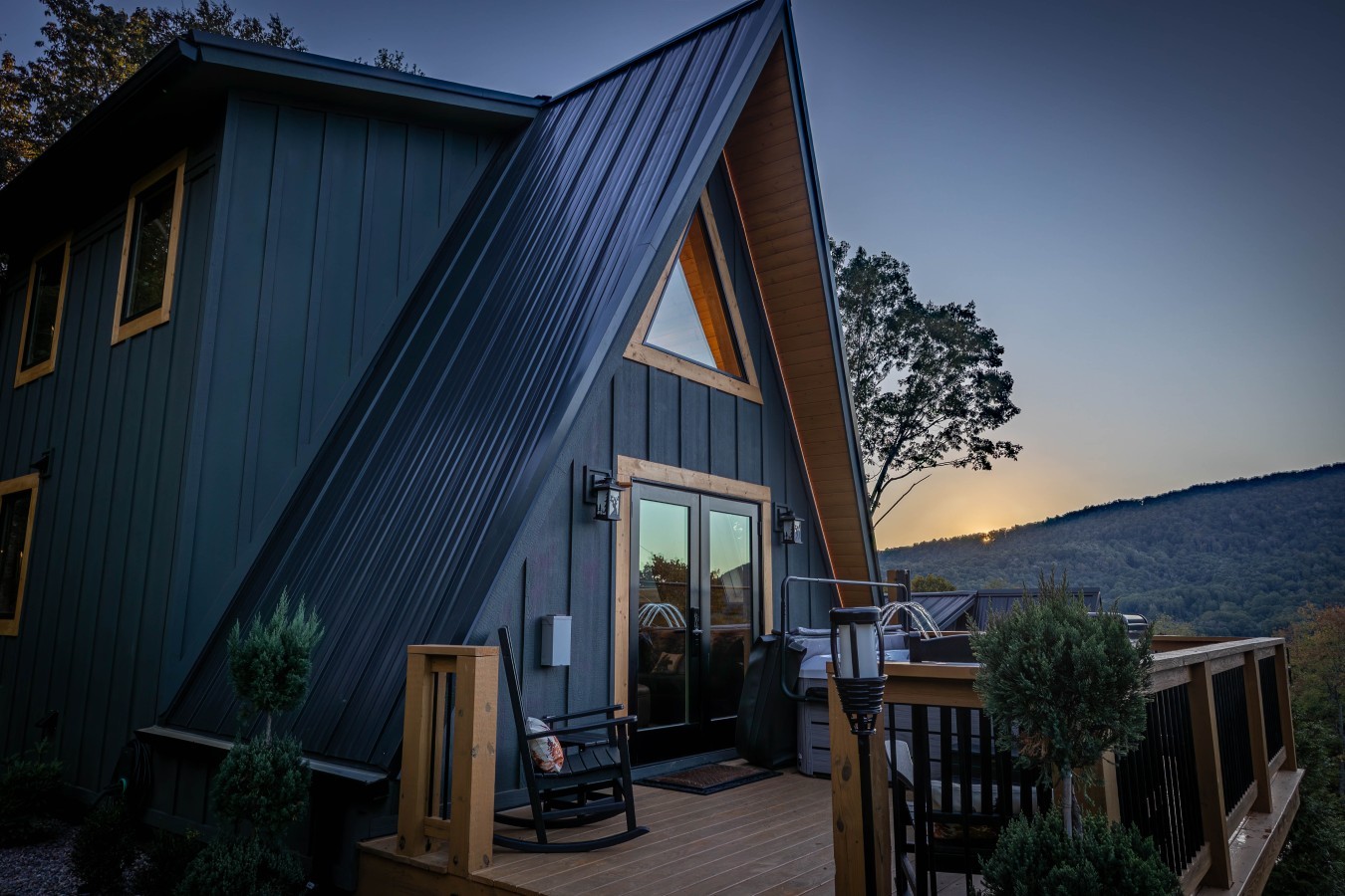 Deck with seating and mountain view at sunset