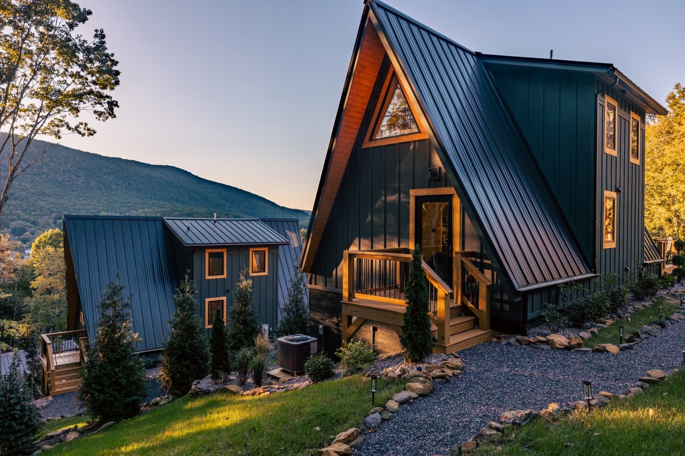 A-frame cabin and gravel path at dusk