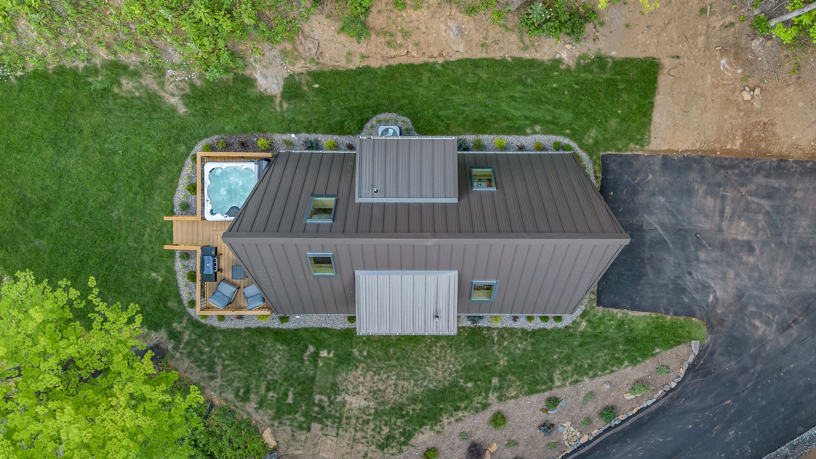 A-frame cabin with the front deck and the mountains behind