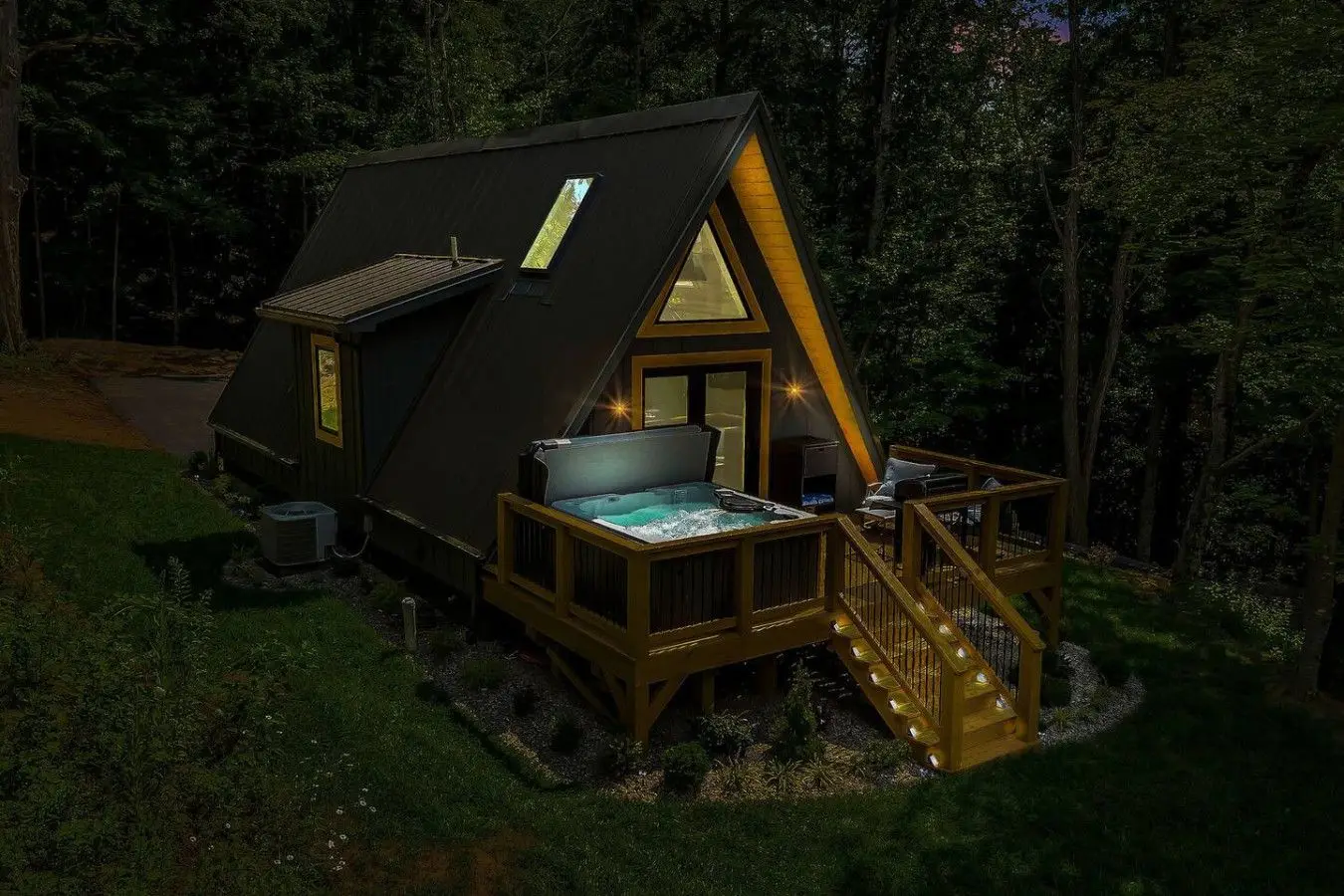 High Peak deck at night with the XL deluxe hot tub glowing